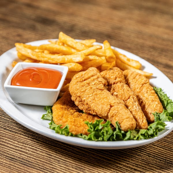 Crispy chicken tenders, golden french fries, and a side of ketchup on a white plate.