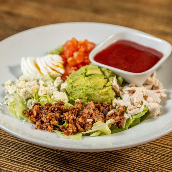 A Rooster Run Cafe Cobb salad with chicken, bacon, avocado, egg, tomato, and blue cheese.